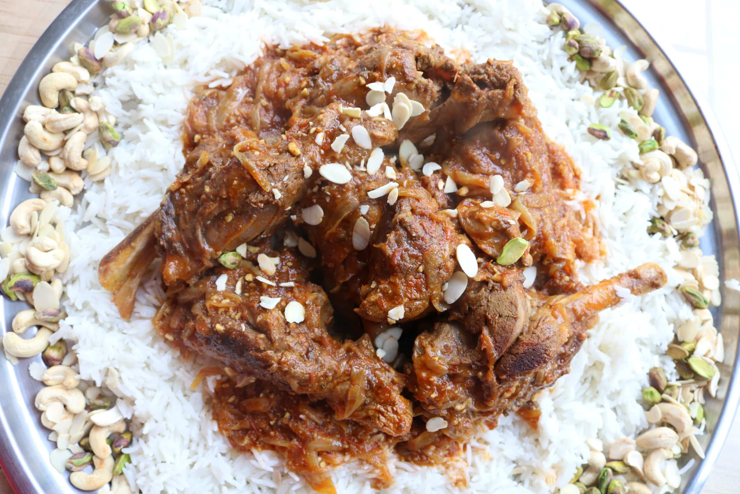 lamb shanks on bed of rice and nuts