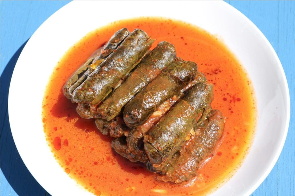 Stuffed grape leaves in tomato sauce